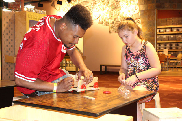 people playing in the air cars exhibit