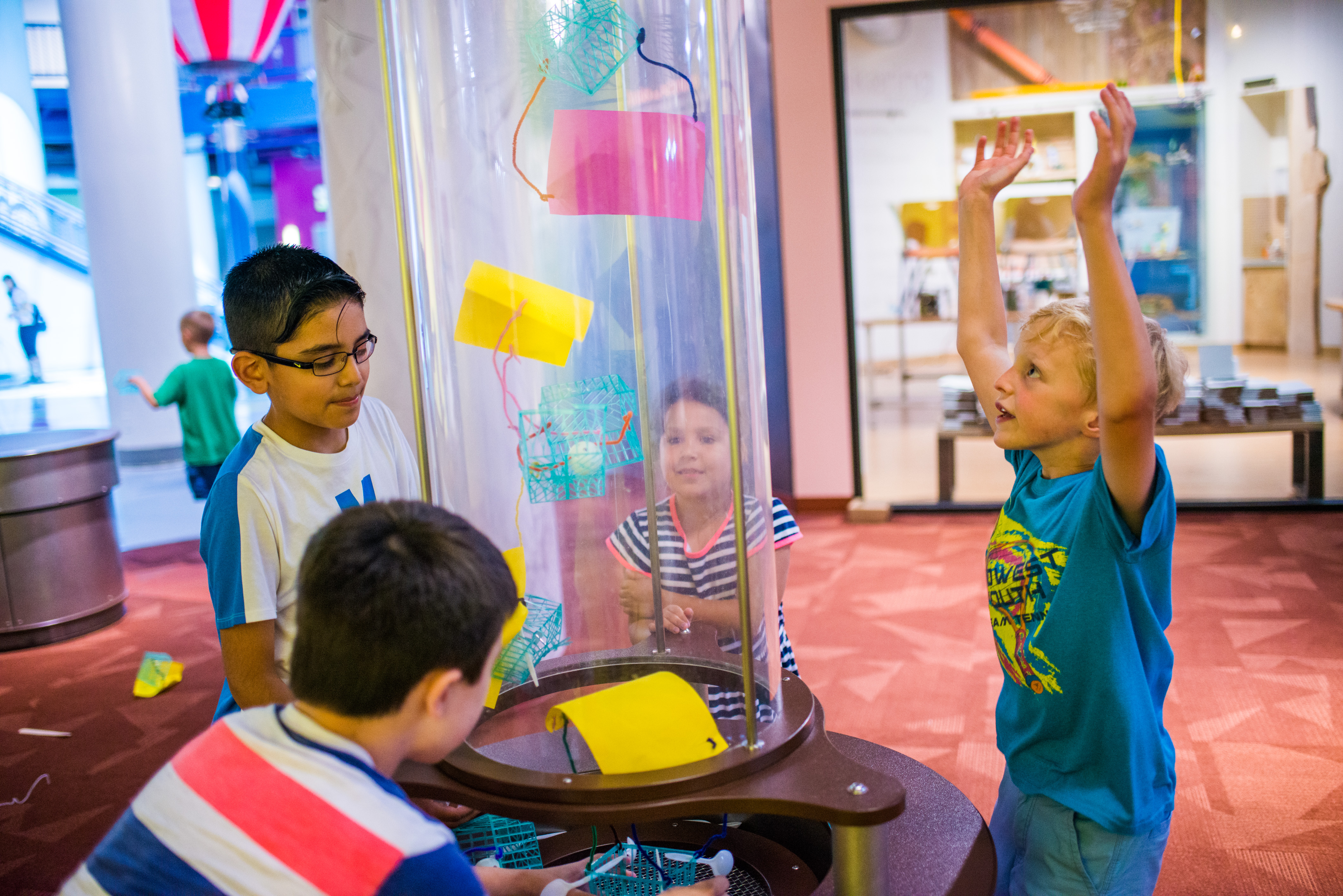 children interacting with the flying things exhibit