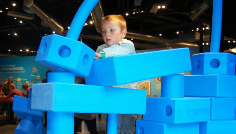 Child climbing on blocks