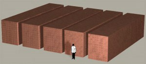 Model of man standing in front of five towers of money