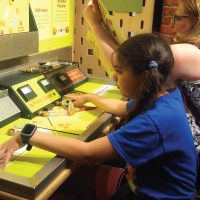 child experimenting with the circuit table